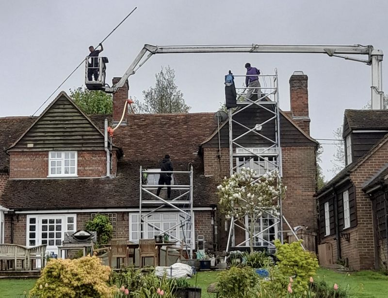 The Roof Moss Cleaners using cherry picker and scaffolding to clean roof safely and professionally in Watford, Hertfordshire
