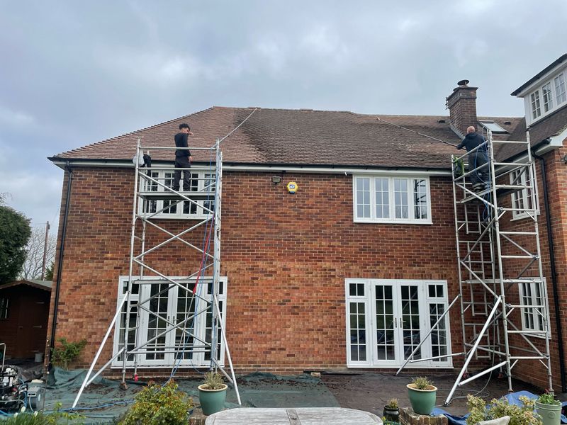 Roof cleaning carried out safely from scaffold towers by The Roof Moss Cleaners in Watford